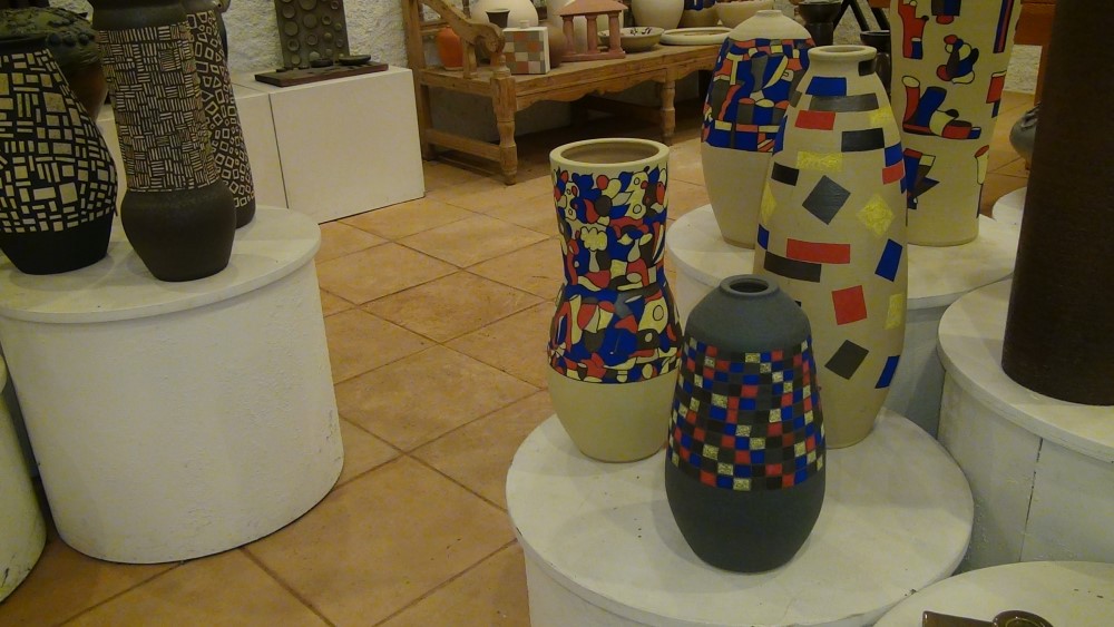 diverses peces altes de coll estret, unes pintades amb colors i altres amb tons beix